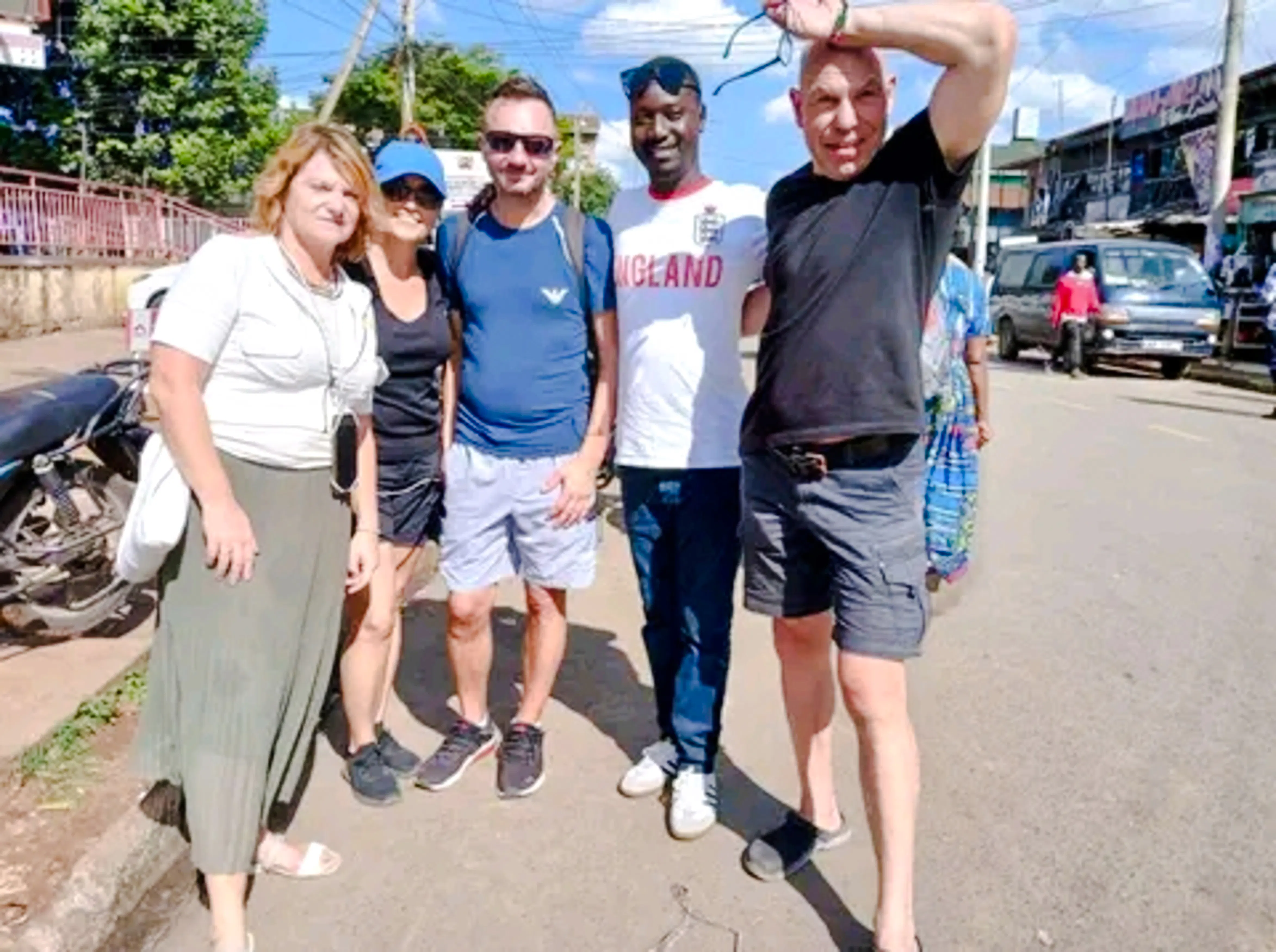 Tourists on a guided walking tour in Nairobi, standing on a city street.
