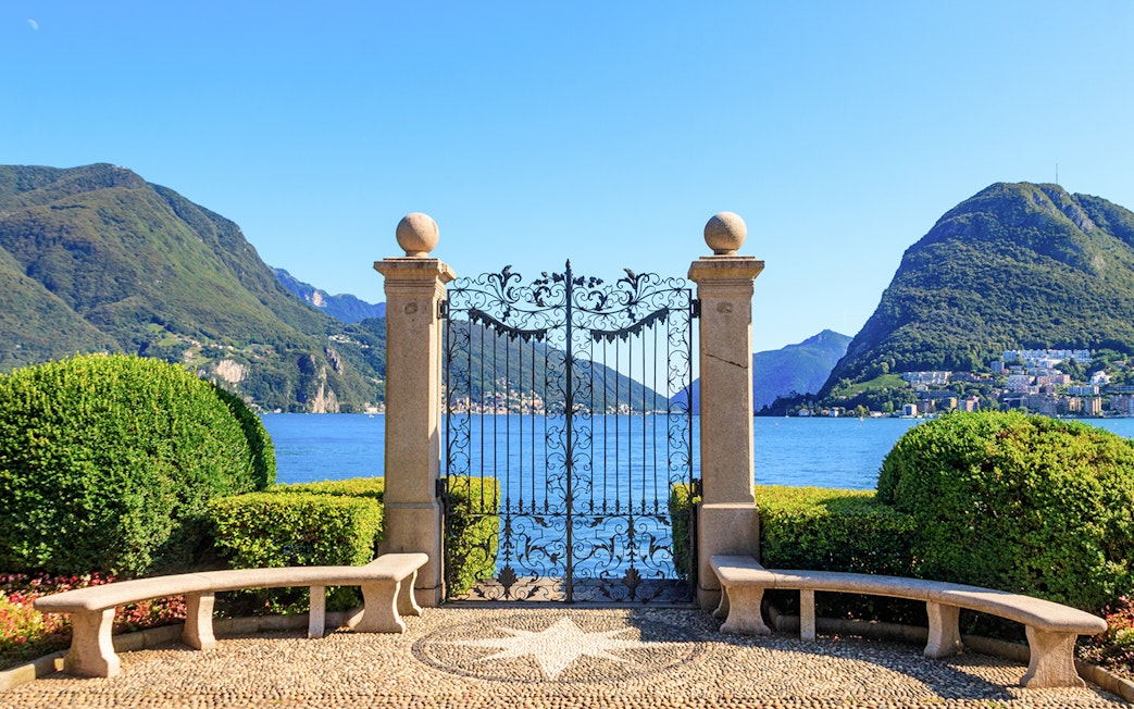Wrought iron gate overlooking Lake Lugano in Ciani Park, Lugano, Switzerland.