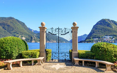 Wrought iron gate overlooking Lake Lugano in Ciani Park, Lugano, Switzerland.