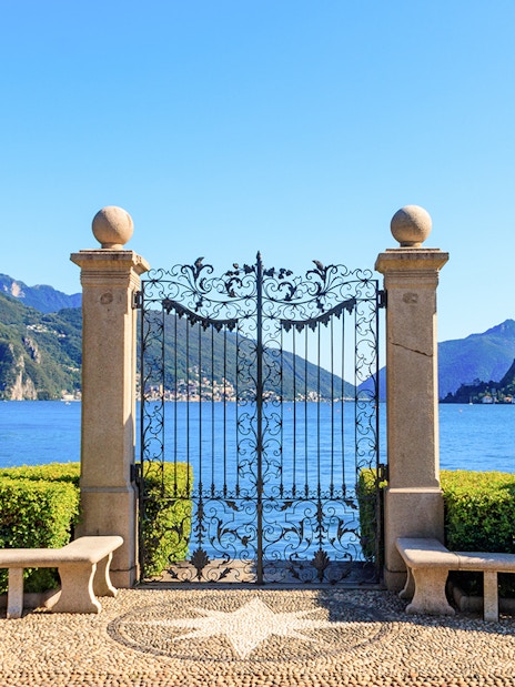Wrought iron gate overlooking Lake Lugano in Ciani Park, Lugano, Switzerland.
