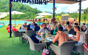 Tourists dining at a lakeside restaurant with views of Cheow Lan Lake, Krabi.