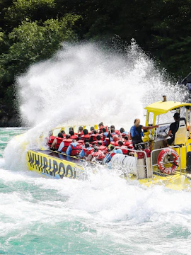 Guests on Whirlpool Jet Boat Tour navigating rapids in Niagara Gorge, Canada.