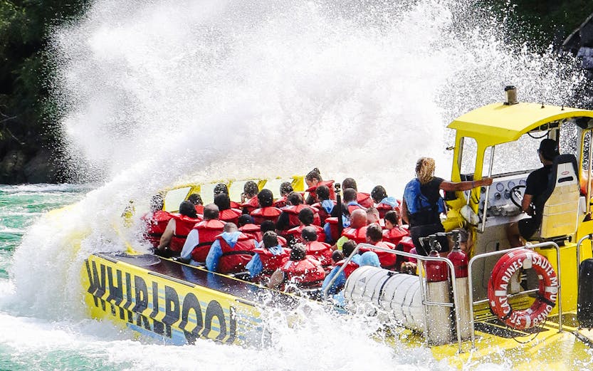 Guests on Whirlpool Jet Boat Tour navigating rapids in Niagara Gorge, Canada.