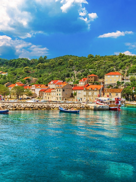 Sipan Island harbor with boats and stone houses, Elaphiti Islands, Dubrovnik, Croatia.