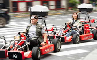 People driving go-karts on Akihabara streets in Tokyo.