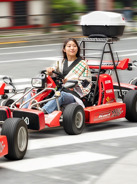 People driving go-karts on Akihabara streets in Tokyo.