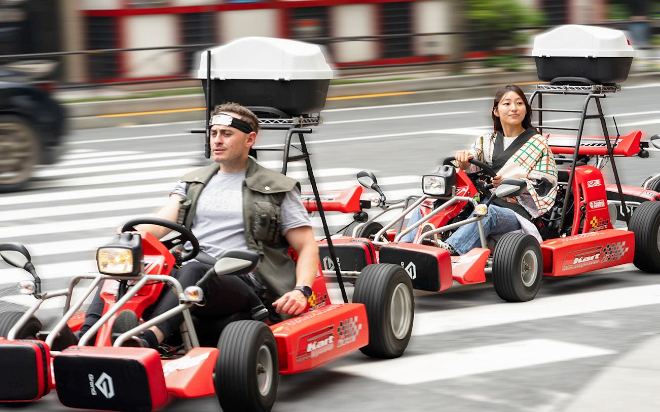 People driving go-karts on Akihabara streets in Tokyo.