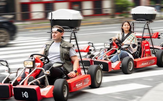 People driving go-karts on Akihabara streets in Tokyo.