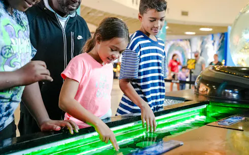 Children interacting with touch tank at The Florida Aquarium, Tampa.