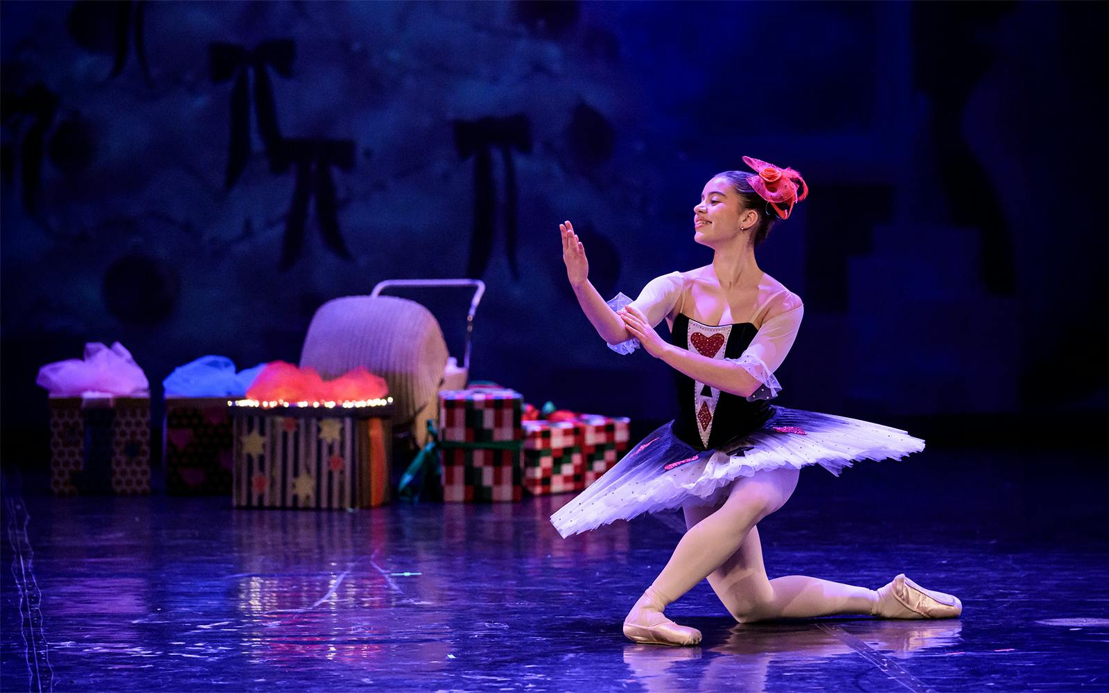 Ballerina performing at a gala in Prague's Old Town with stage props in the background.