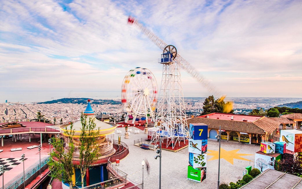 Tibidabo Amusement Park with Ferris wheel and panoramic view of Barcelona.