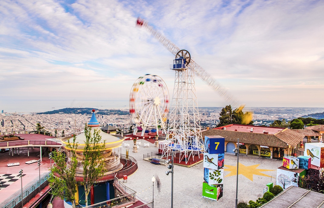 Tibidabo Amusement Park with Ferris wheel and panoramic view of Barcelona.