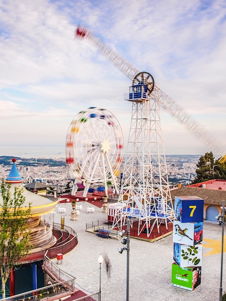 Tibidabo Amusement Park with Ferris wheel and panoramic view of Barcelona.