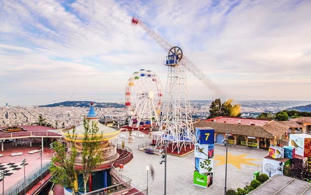 Tibidabo Amusement Park with Ferris wheel and panoramic view of Barcelona.