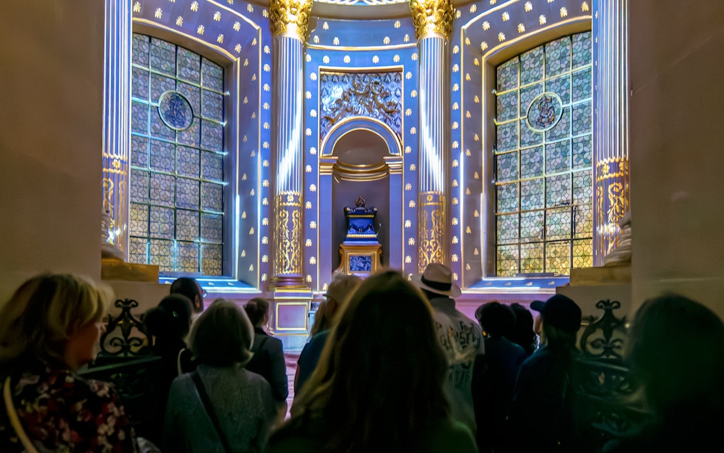 Visitors experiencing Aura Immersive light show at Invalides, Paris.