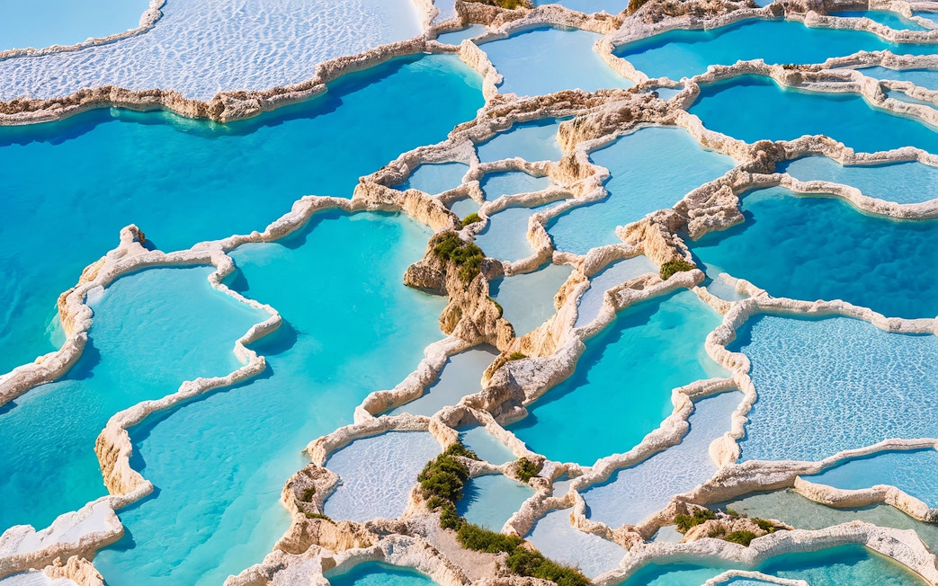 Aerial view of Pamukkale's terraced thermal pools in Turkey.