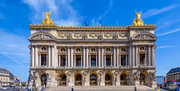 Tourists exploring the magnificent Opéra Garnier in Paris, known for its stunning architecture and rich history
