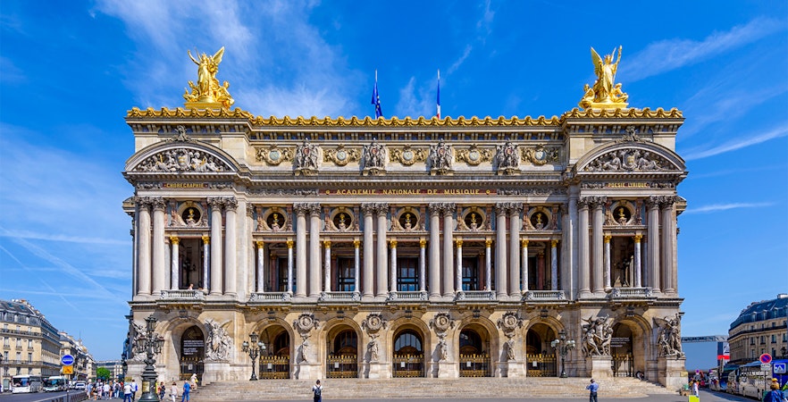 Tourists exploring the magnificent Opéra Garnier in Paris, known for its stunning architecture and rich history