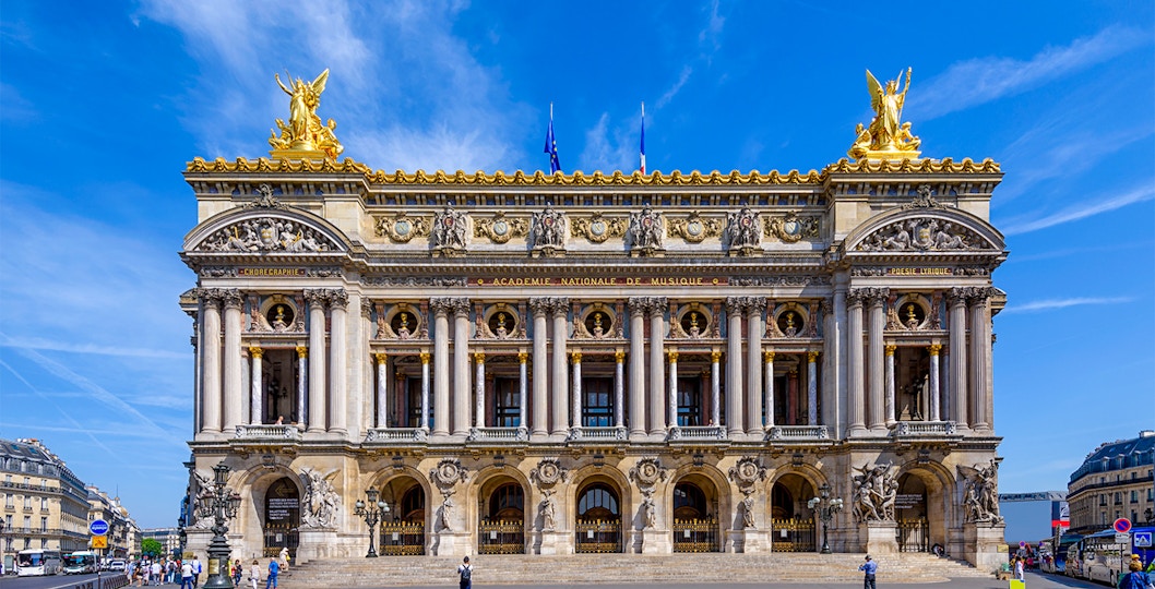 Tourists exploring the magnificent Opéra Garnier in Paris, known for its stunning architecture and rich history