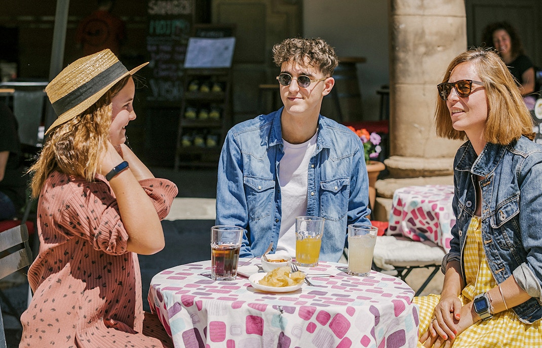 Tourists enjoying drinks and food during their visit to Poble Espanyol