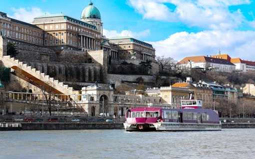 Cruise ship sailing by Buda Castle in Budapest, Hungary.