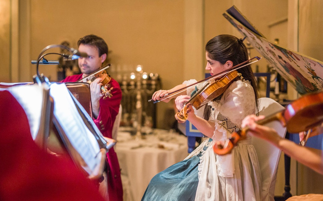 Musicians in period costumes performing at a Mozart concert in Salzburg.