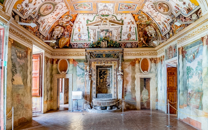 Villa d’Este interior with ornate frescoes and detailed ceiling in Tivoli, Italy.