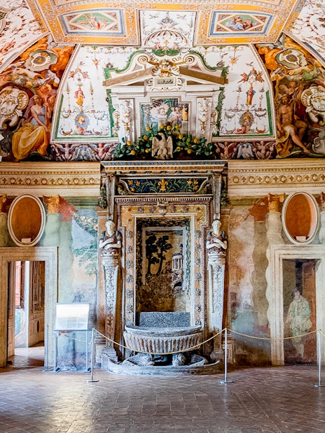 Villa d’Este interior with ornate frescoes and detailed ceiling in Tivoli, Italy.