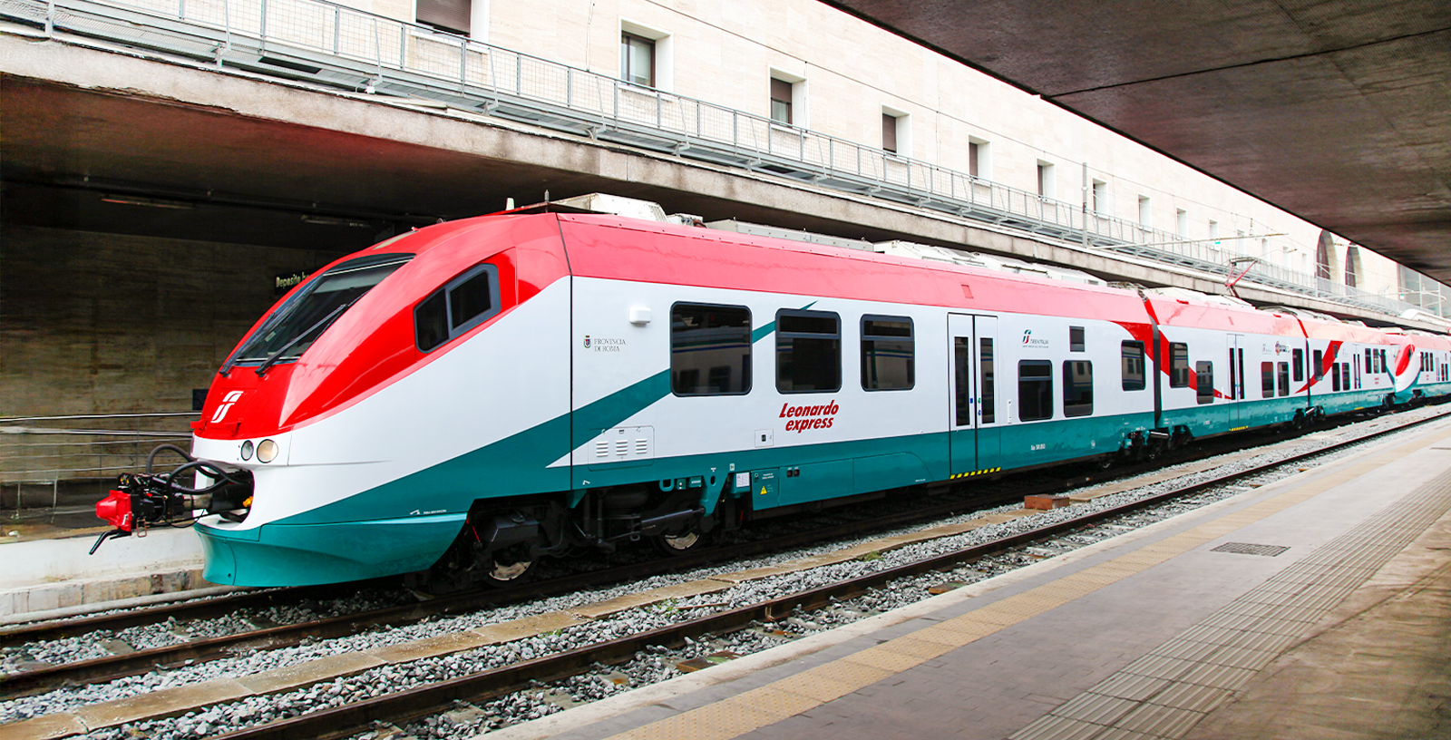 Leonardo Express train at Rome's Termini Station platform, connecting to Fiumicino Airport.