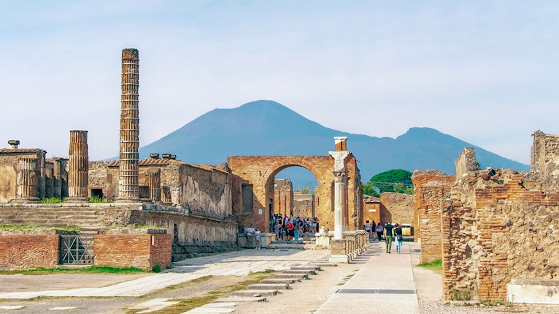 Pompeii Archaeological Park officials examining mosaic
