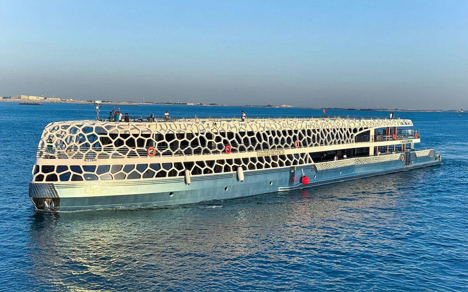 Dubai Marina yacht cruise with buffet dinner, unlimited drinks, and live entertainment.