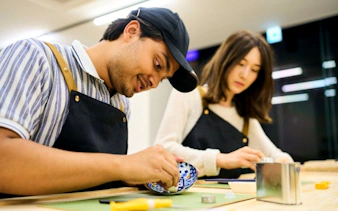 Participants repairing pottery at a Kintsugi workshop in Shinjuku, Tokyo.