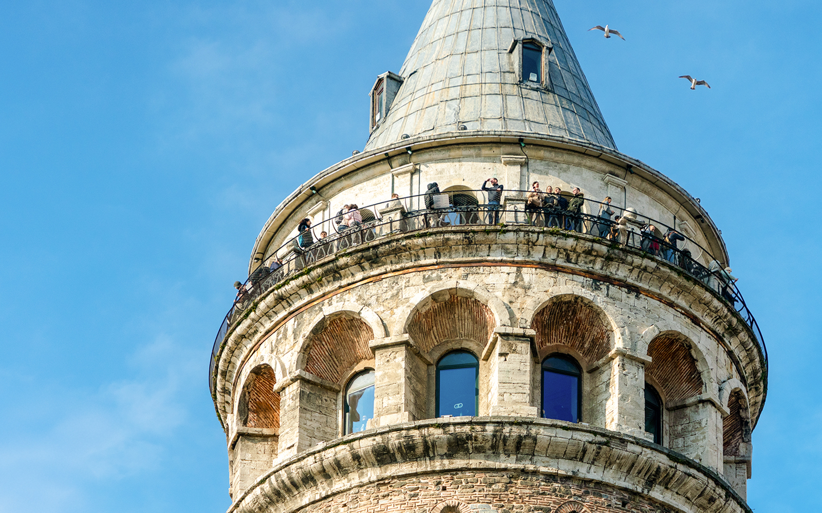 Visitors on the observation deck of Galata Tower, overlooking Istanbul, Turkey.