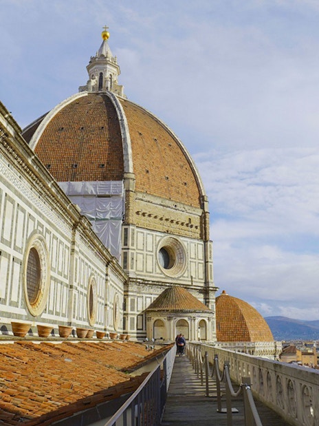 Terrace view of Florence Cathedral with dome and cityscape in the background.