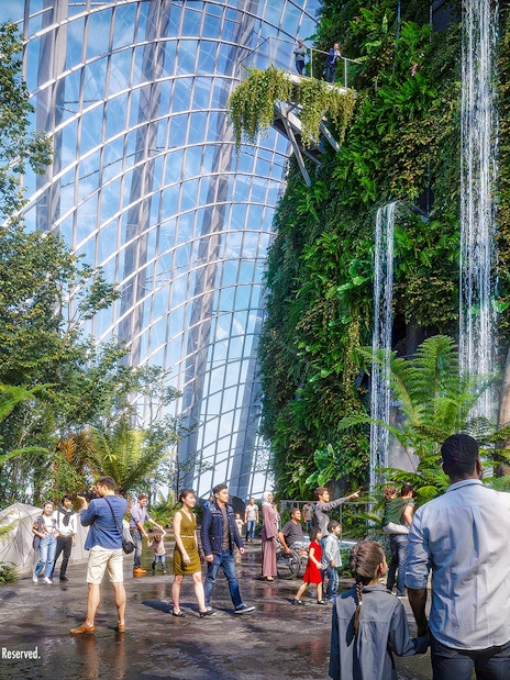 Visitors at Gardens by the Bay exploring the Jurassic World exhibit with dinosaur sculptures.