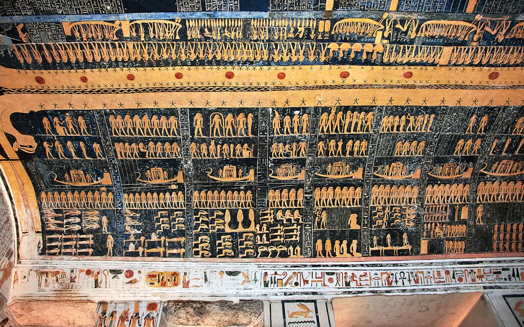 Ancient Egyptian hieroglyphs on a tomb ceiling in the Valley of Kings, Luxor, Egypt.