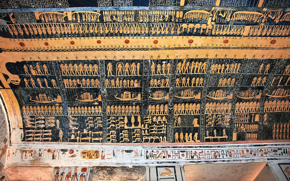 Ancient Egyptian hieroglyphs on a tomb ceiling in the Valley of Kings, Luxor, Egypt.