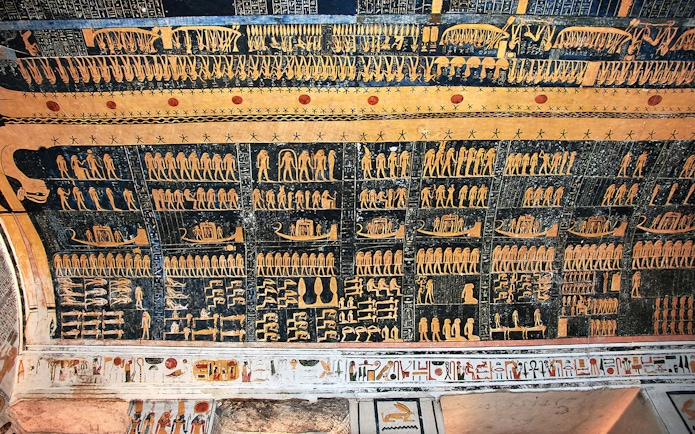 Ancient Egyptian hieroglyphs on a tomb ceiling in the Valley of Kings, Luxor, Egypt.