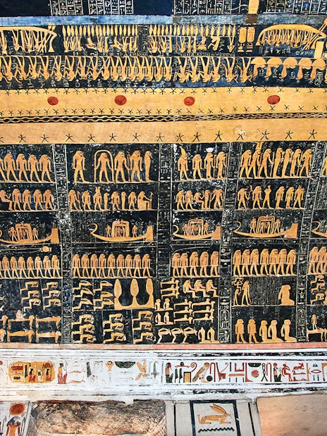 Ancient Egyptian hieroglyphs on a tomb ceiling in the Valley of Kings, Luxor, Egypt.