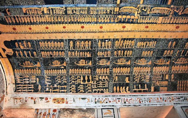 Ancient Egyptian hieroglyphs on a tomb ceiling in the Valley of Kings, Luxor, Egypt.