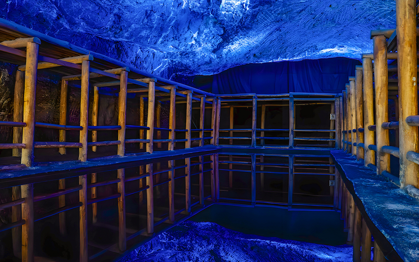 Water mirror reflecting wooden structures in Salt Cathedral of Zipaquirá, Colombia.