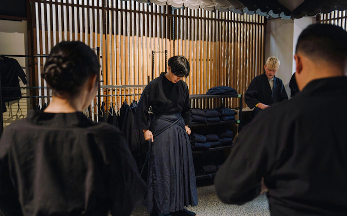 Participants preparing for Samurai Sword Experience in Shinjuku, wearing traditional attire.