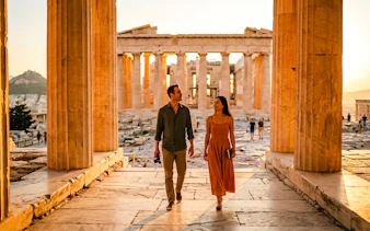 Guests walking through the Acropolis in Athens at sunset.