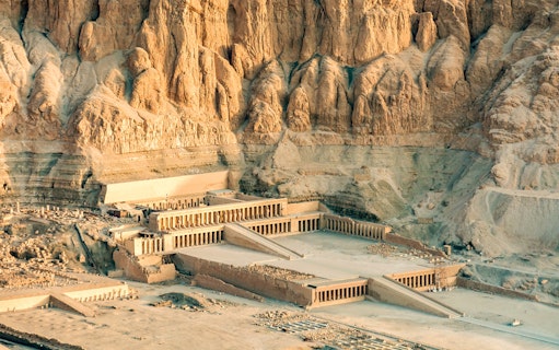 Hatshepsut Temple in Luxor's Valley of the Queens, Egypt, with surrounding cliffs.