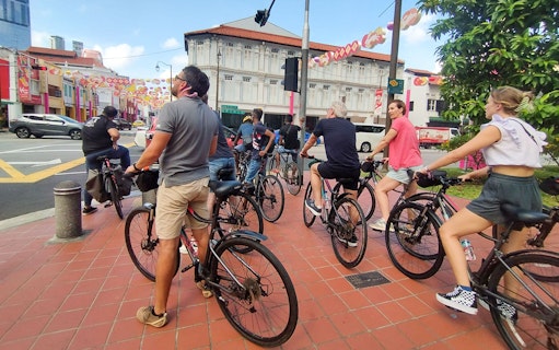 Cyclists on a guided historical bike tour in Singapore's Chinatown.