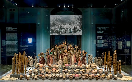 Exhibit of cultural artifacts and masks at Weltmuseum Vienna.