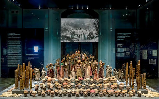 Exhibit of cultural artifacts and masks at Weltmuseum Vienna.