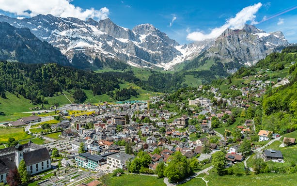Engelberg cityscape with snow-capped mountains and traditional Swiss architecture.