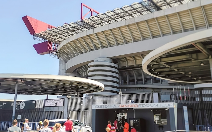 San Siro stadium exterior with ticket office and visitors in Milan, Italy.