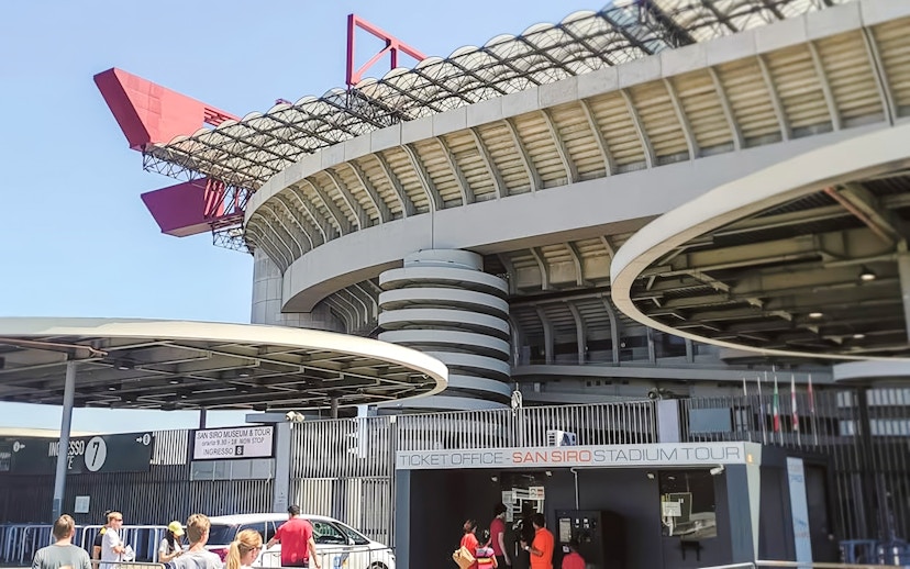 San Siro stadium exterior with ticket office and visitors in Milan, Italy.